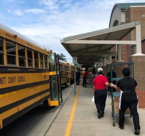 Loading school buses to deliver meals to children